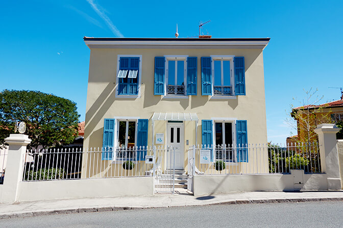 French Yellow Building with Blue Shutters